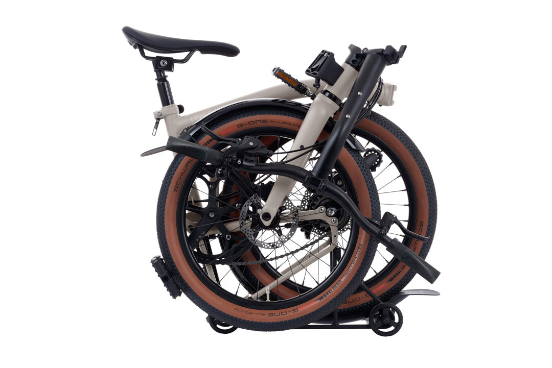 Brompton G Line Folded bicycle on a white background