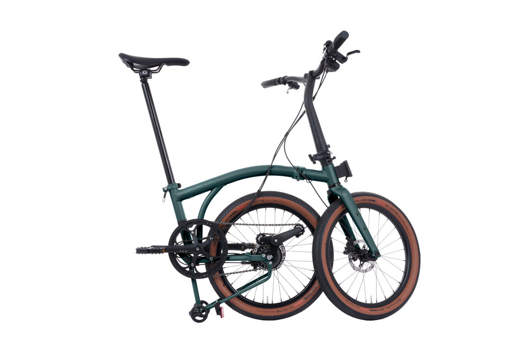 Brompton G Line Green bicycle with brown tires on a white background