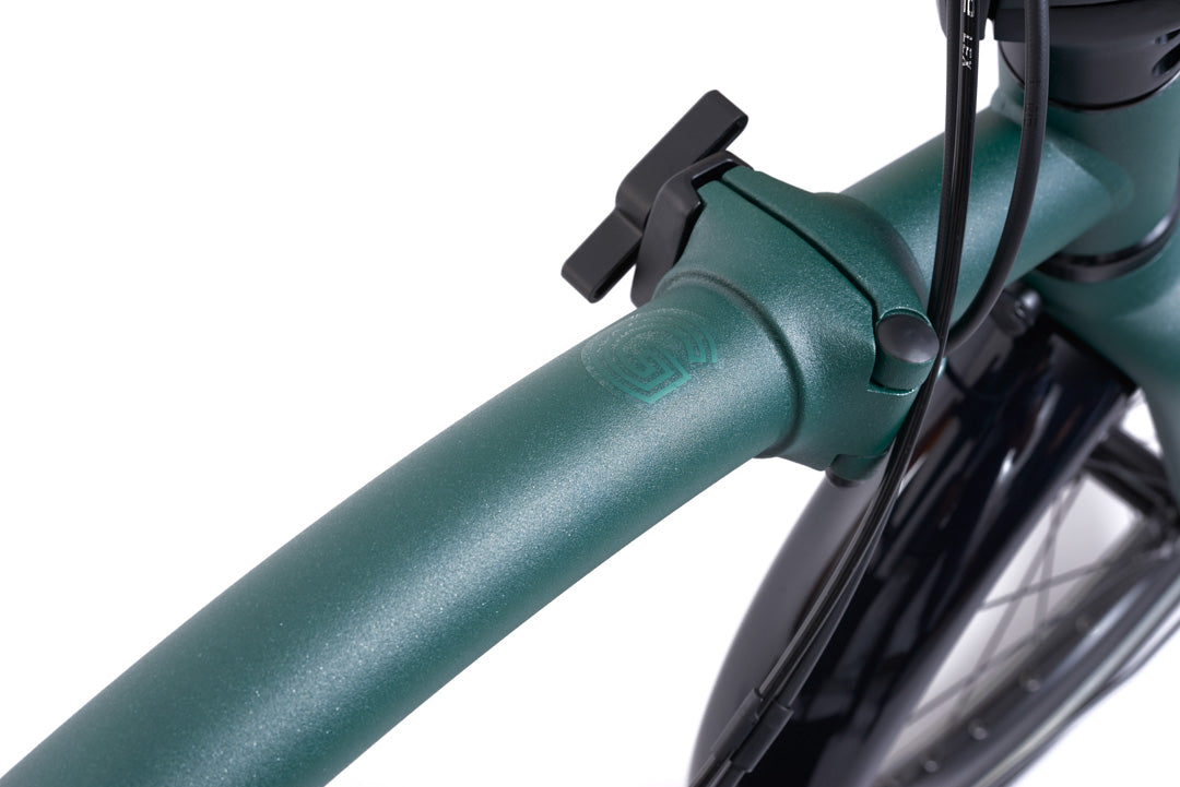 Brompton G Line Close-up of a green bicycle handlebar with a black clamp on a white background