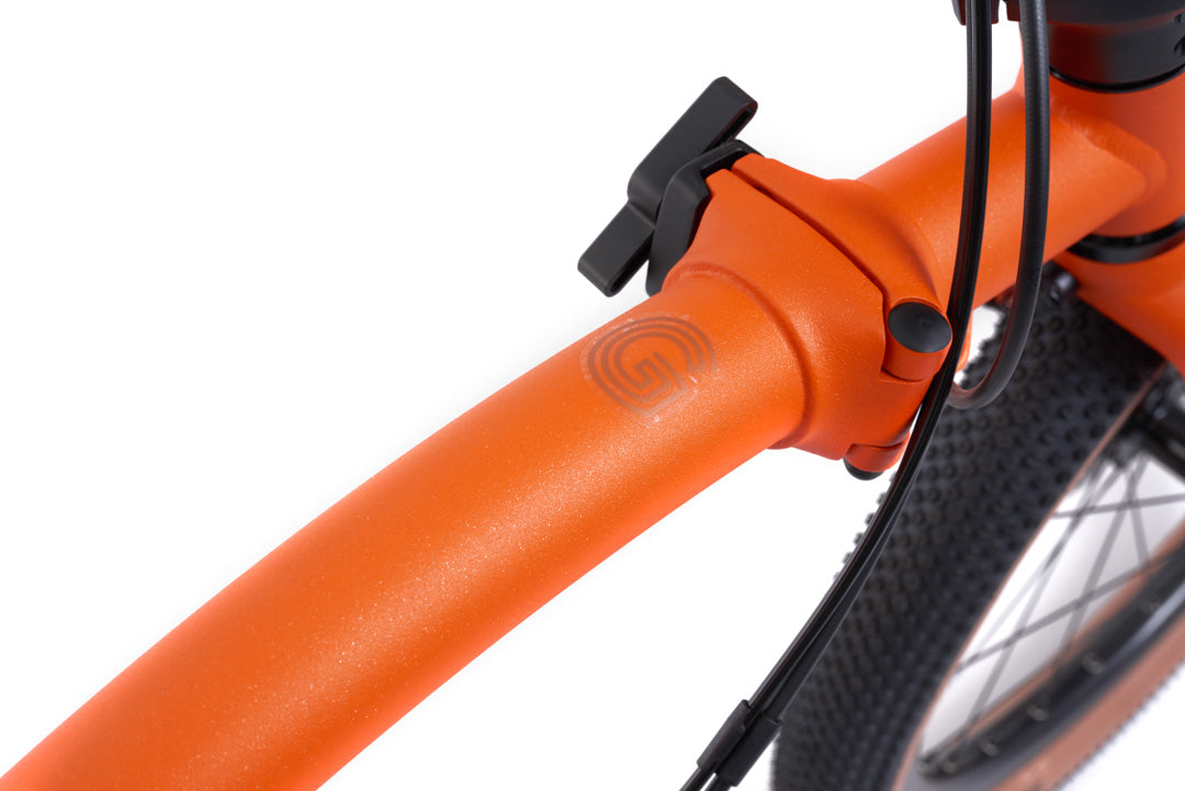 Brompton G Line Close-up of an orange bicycle frame with a white background