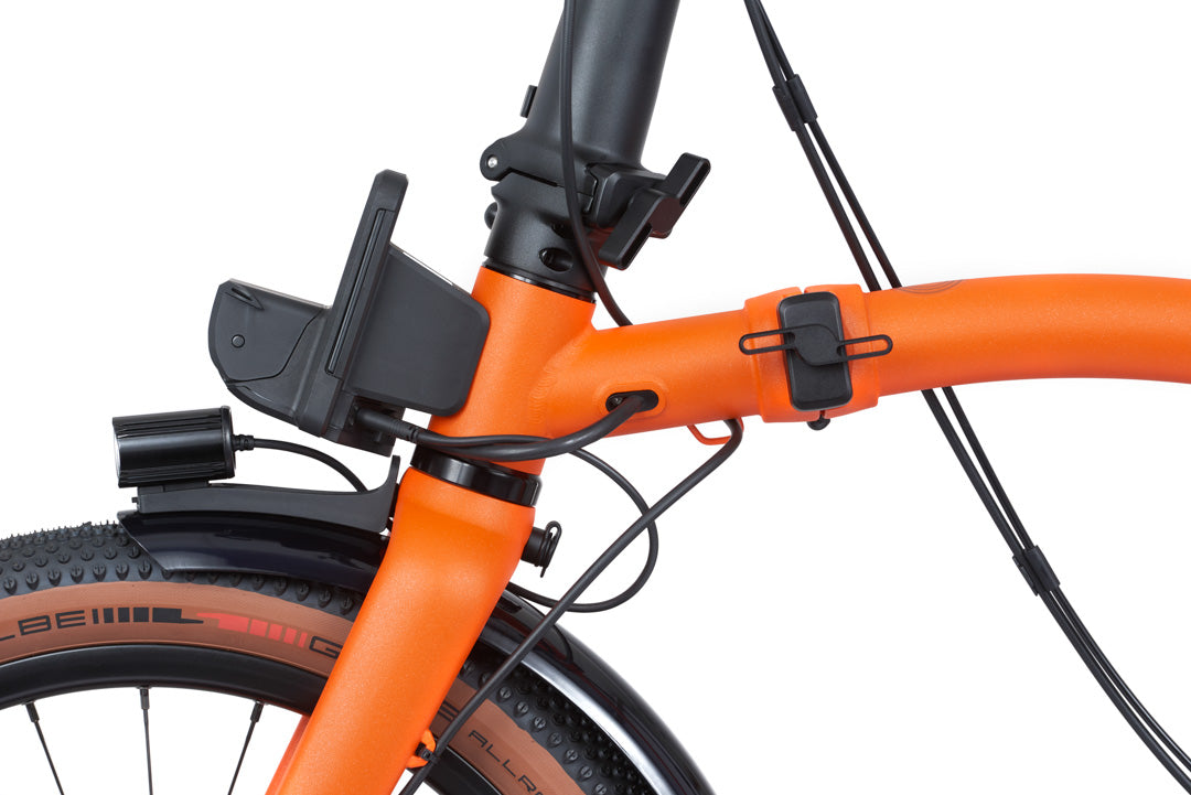Brompton G Line Close-up of an orange bicycle frame with a smartphone mount on a white background